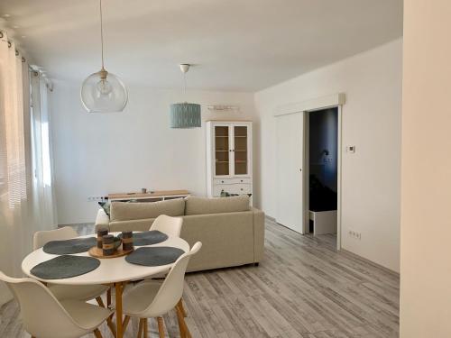 a living room with a table and a couch at Old Town Apartment Székesfehérvár in Székesfehérvár