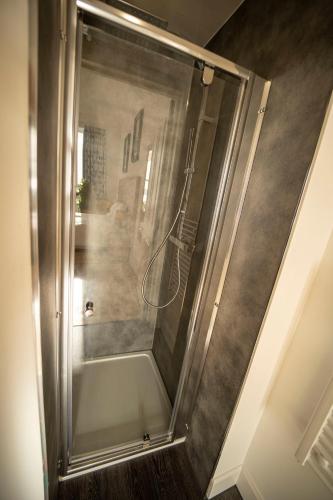 a shower with a glass door in a room at The Clarendon in Dundee
