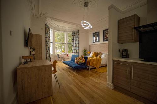 a living room with a couch and a bed at The Clarendon in Dundee