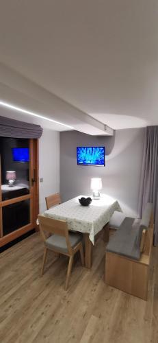 a dining room with a table and a couch at Landhaus Thaler in Mittelberg