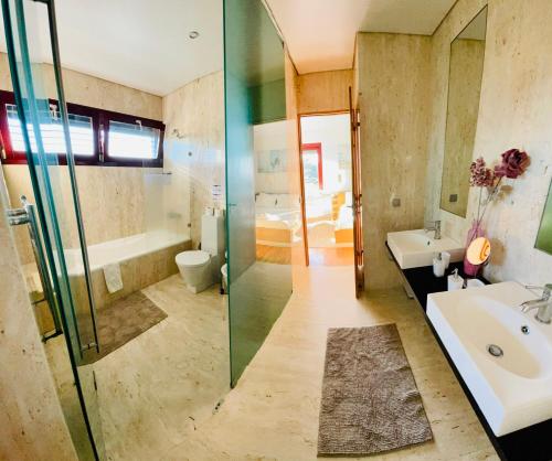a bathroom with a shower and a sink and a toilet at I Love U villa in Ericeira