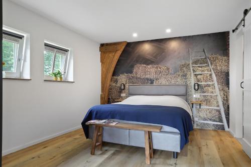 a bedroom with a blue bed and a ladder at Vakantiehuis Bij Vermeer in Een