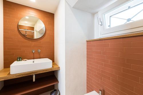 a bathroom with a white sink and a mirror at Casa Badia Bed & Breakfast in Conversano