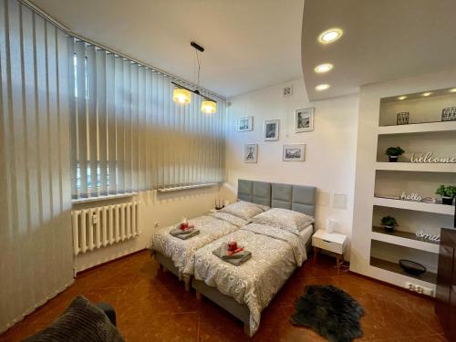 a bedroom with a bed and a large window at Apartament Gryf in Gryfów Śląski