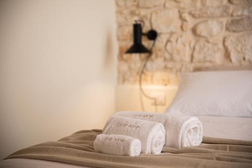 two rolled towels on a bed in a bedroom at Casa Badia Bed & Breakfast in Conversano
