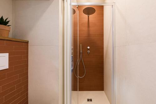 a shower with a glass door in a bathroom at Casa Badia Bed & Breakfast in Conversano