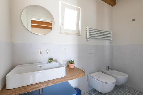 a bathroom with a tub and a toilet and a mirror at Casa Badia Bed & Breakfast in Conversano