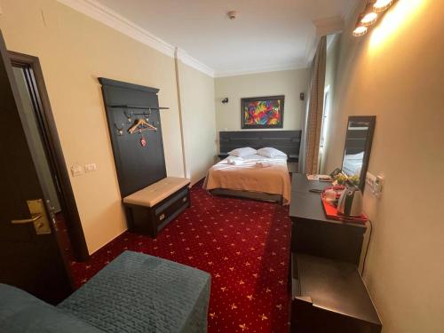 a hotel room with two beds and a red carpet at Casa Bucovineana in Suceava