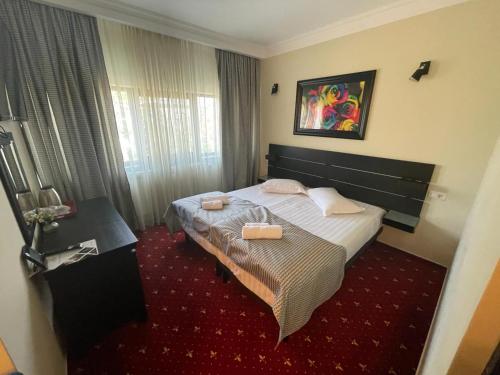 a hotel room with a bed with two dishes on it at Casa Bucovineana in Suceava