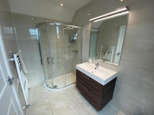 a bathroom with a sink and a shower at Atlantic Retreat Lodge in Kinvara