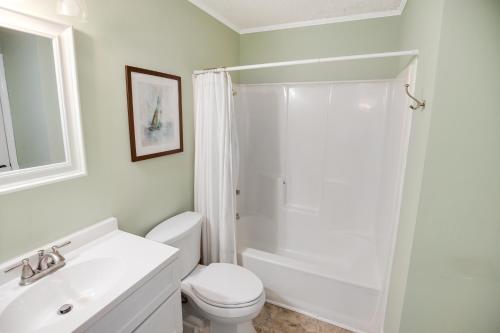 a white bathroom with a shower and a toilet at 2BR, 2Bath condo Oceanfront Getaway with pool in Myrtle Beach