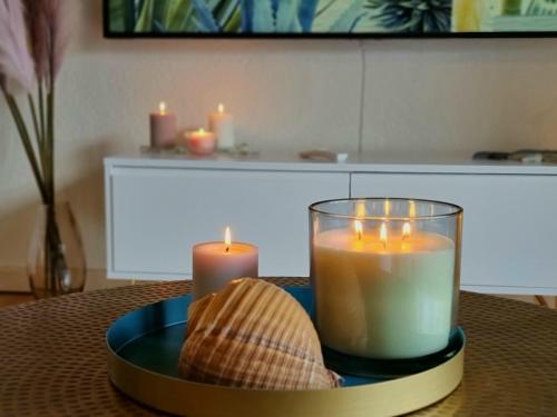 a table with candles and a plate with a shell at Fischerhüsli directly on lake Thun in Därligen