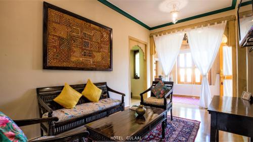 a living room with a couch and a table at The Gulaal in Jaisalmer