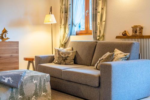 a living room with a couch and a chair at Charming Civetta in Alleghe