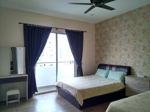 a bedroom with a bed and a large window at Premium Garden Home 17 Golden Hills in Brinchang