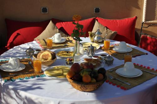 a table with a table cloth with food on it at Riad Jnan El Cadi in Marrakech