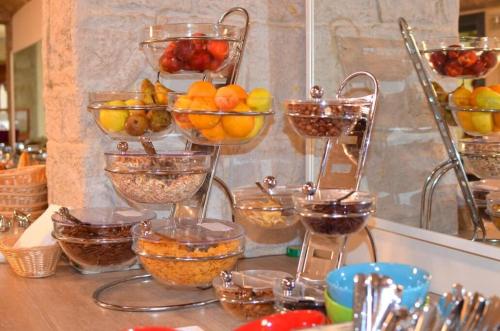 a counter with bowls of fruit and other food at Hotel Seestuben in Villach