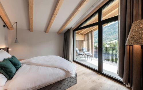 Un pat sau paturi într-o cameră la Residence Le Fostü
