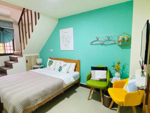 a bedroom with blue walls and a bed and chairs at Er Jie's House in Jinning