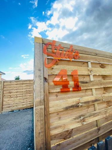 a wooden fence with an orange sign on it at Studio 41 in Eppeville