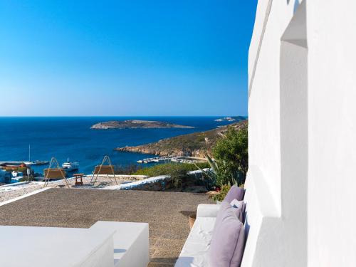 a view of the ocean from a white building at The Windmill Kimolos in Kimolos