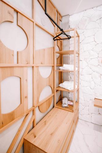 a room with wooden shelves and a wall at Kardias Luxury Suites in Iraklitsa