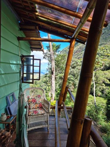 a porch of a house with a swing at Chales Bamboo Jungle in Petrópolis