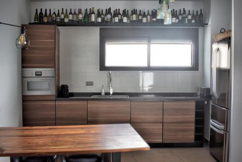 a kitchen with a wooden table and a window at Home Apartments Jerez in Jerez de la Frontera