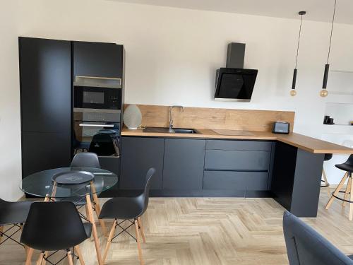 a kitchen with a table and chairs and a counter at Chjama di mare in Santa-Maria-di-Lota
