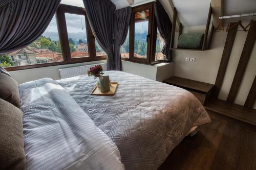 a bedroom with a bed with a tray with flowers on it at Giataki in Elati Trikalon