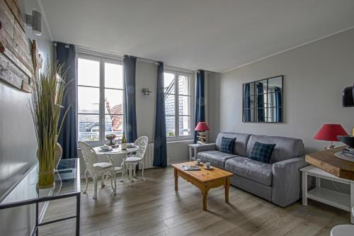 un salon avec un canapé et une table dans l'établissement La Venelle du Bassin, à Honfleur