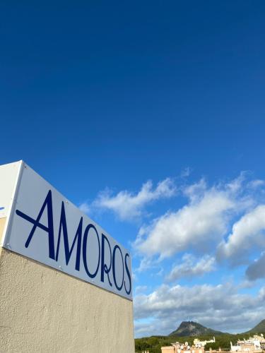 a sign on the side of a building at Hotel Amoros in Cala Ratjada