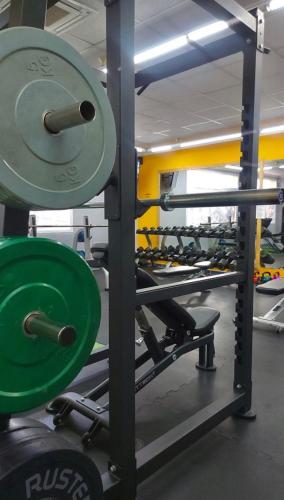 a gym with a row of dumbbells on a rack at Hotel Amoros in Cala Ratjada