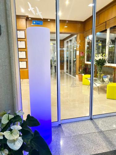 an empty lobby with a blue door in a building at Hotel Amoros in Cala Ratjada