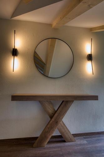 a mirror on a wall with a wooden table at Giataki in Elati Trikalon