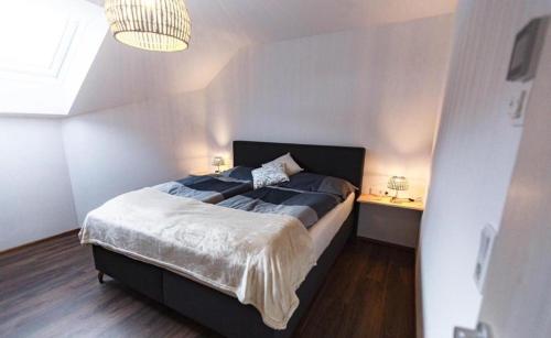 a bedroom with a bed and a chandelier at Das Dorfnest in Sankt Margarethen im Lungau
