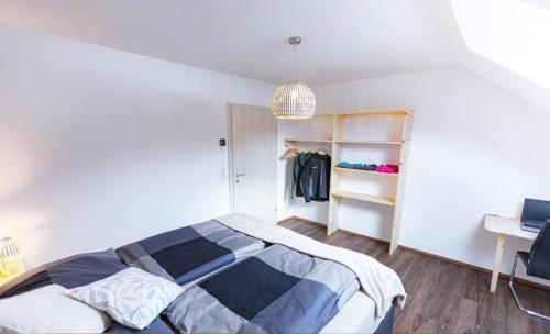 a bedroom with a bed and a closet at Das Dorfnest in Sankt Margarethen im Lungau