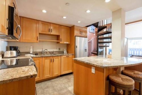a kitchen with wooden cabinets and a counter top at Condo with Hot Tub Free Garage Parking in Vail