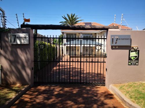 a gate in front of a house with a residence at 17 on 13th in Edenvale