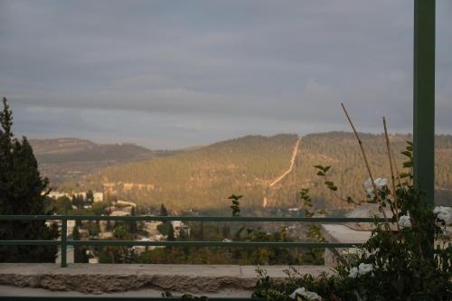 a view of a mountain with a road in the distance at Khan Ein Karem Boutique Hotel in Jerusalem