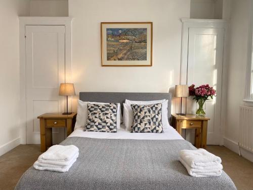 a bedroom with a large bed with two night stands at Stylish Maisonette and Studio in Victoria in London