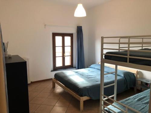 a bedroom with two bunk beds and a window at Camera San Jacopo in Altopascio