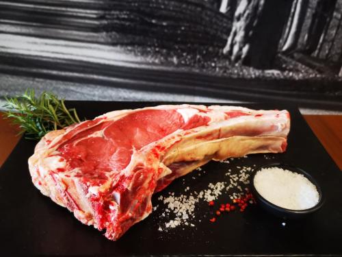 a piece of meat sitting on top of a black plate at SESIMA turismo rurale in Mistretta