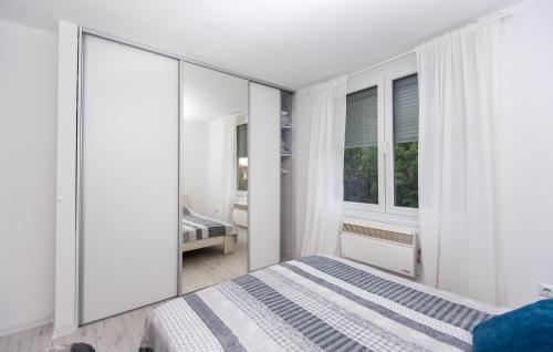 a bedroom with a bed and a large mirror at Apartment Kalemova in Sarajevo