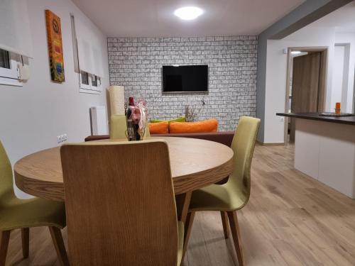 a dining room with a wooden table and chairs at CASA DI NIMA in Ioannina