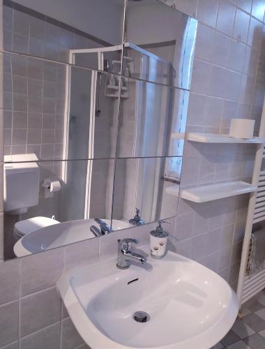 a bathroom with a sink and a mirror and a tub at Le Ruote in Vezzano sul Crostolo