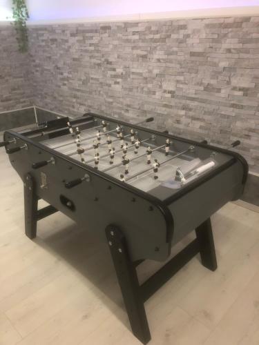 a black pool table sitting on top of a floor at Villa del catalunya in Perpignan