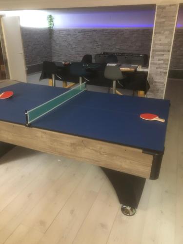a blue ping pong table in a room at Villa del catalunya in Perpignan