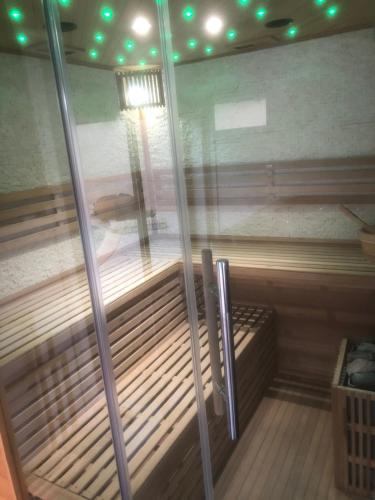 a sauna with a glass door with a bench in it at Villa del catalunya in Perpignan