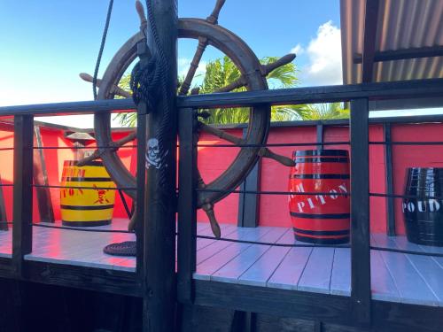 a group of colorful barrels sitting on a balcony at Piton Bungalows Ecolodges in Deshaies